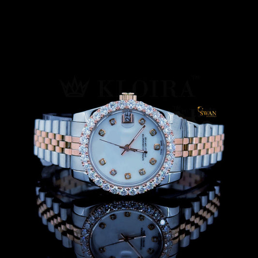 Two-tone watch with a white dial, a diamond-encrusted bezel, and a silver and rose gold link band with a date display by swandiamond