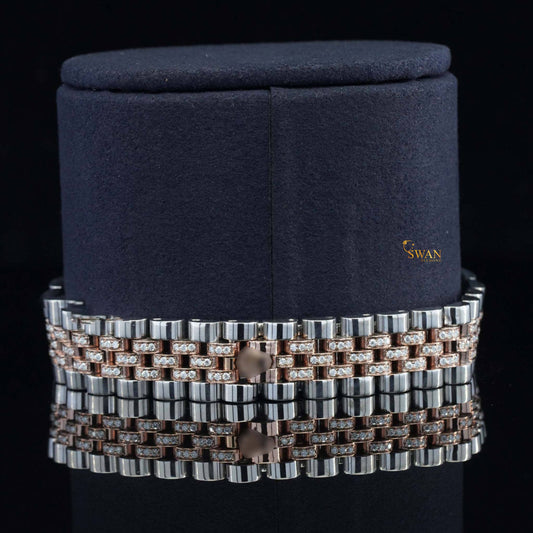 Silver-toned and gold iced-out watch with a green dial, a diamond-encrusted bezel, and a link band by swandiamond