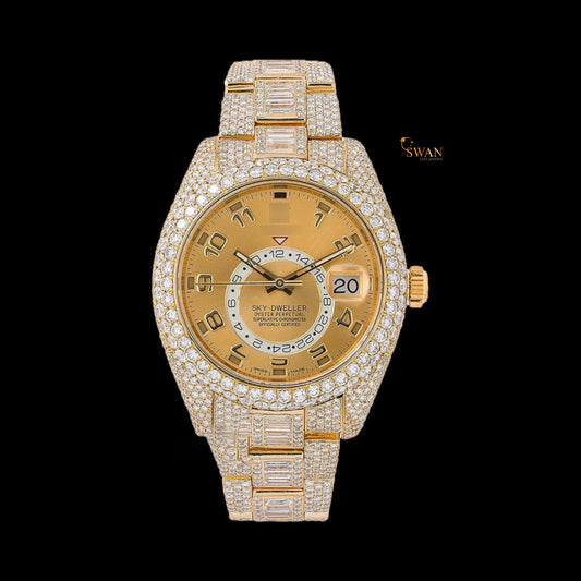 Full gold iced-out Sky-Dweller watch with a pave and baguette diamond bezel, and a date display on a link band by swandiamond
